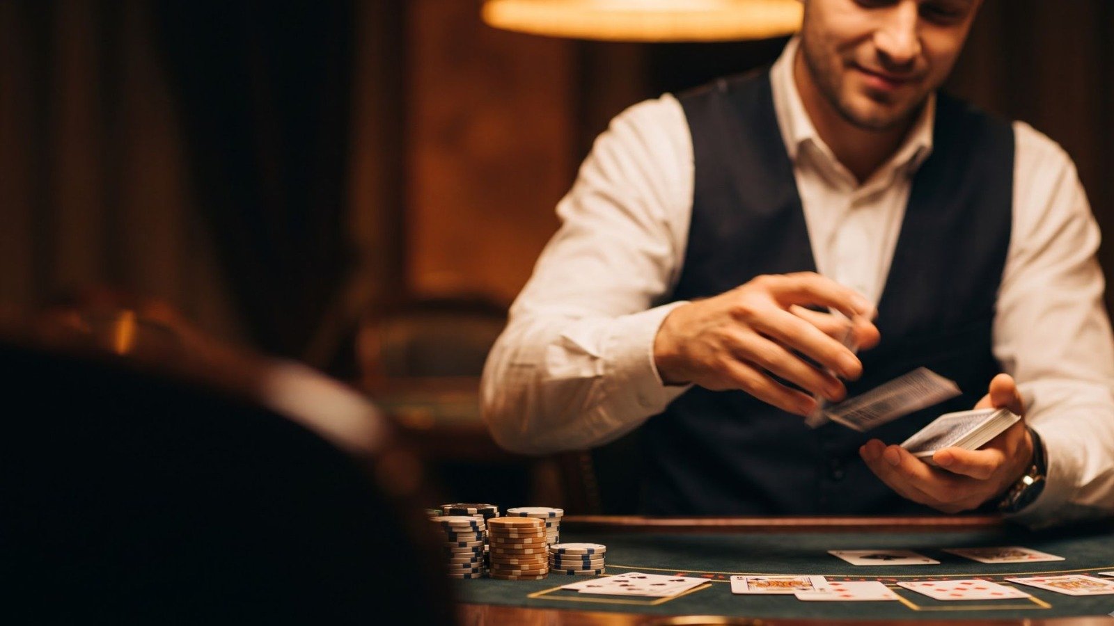 Live casino table with chips and cards under warm gold lighting
